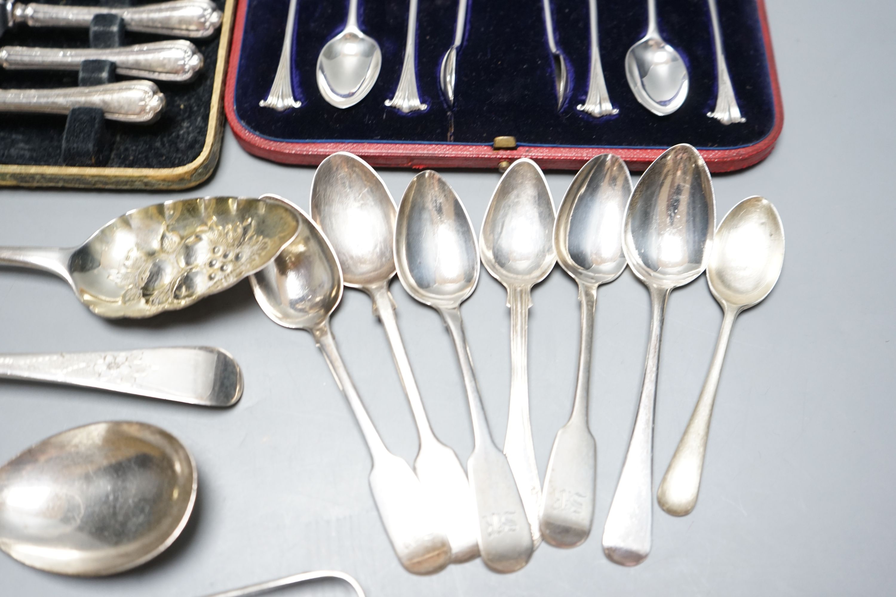 Two George III silver 'berry' spoons, seven other silver spoons, pair of silver tongs, a Swedish white metal teaspoons and two cased sets including silver teaspoons.